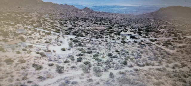 a large stone wall with a mountain in the background