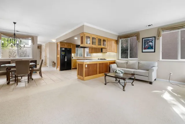 a kitchen with granite countertop a sink and white cabinets