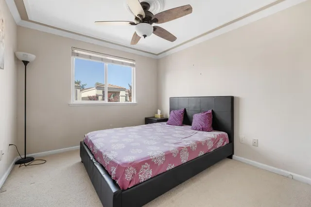 a bedroom with a bed and a painting on the wall