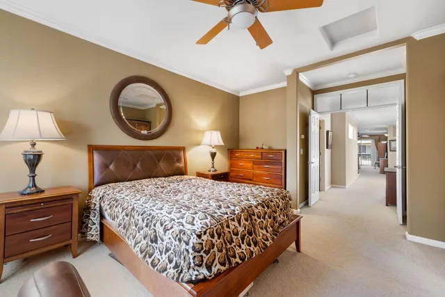 a living room with a bed furniture and a flat screen tv