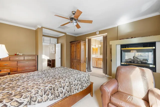 a bedroom with a bed and a large window with outer view