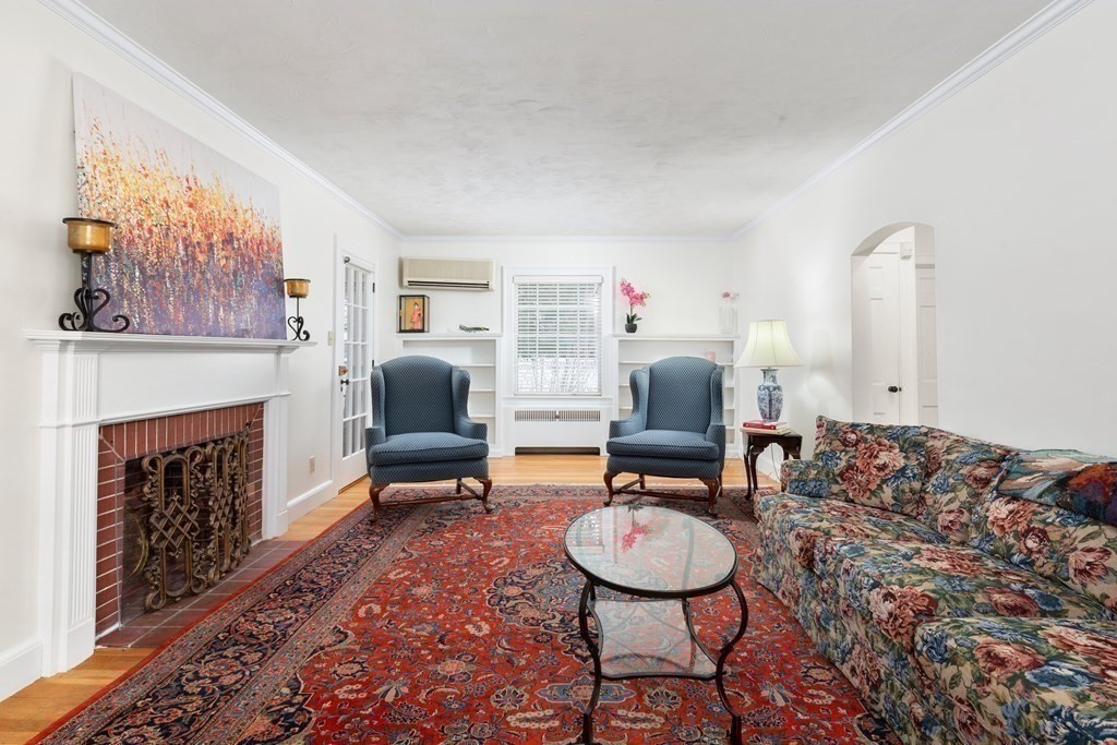 7 Gordon Road Milton, MA 02186 - Photo 2 of 17 a living room with furniture and a fireplace