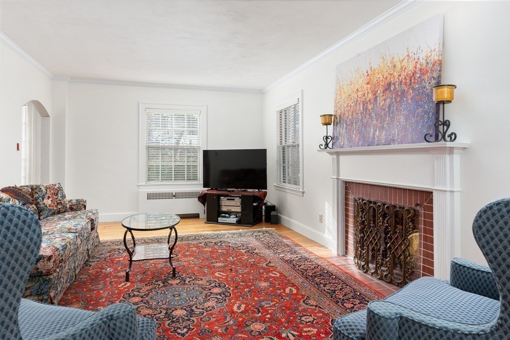 7 Gordon Road Milton, MA 02186 - Photo 5 of 17 a living room with furniture a fireplace and a flat screen tv
