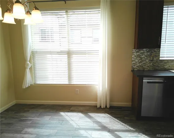 a kitchen with granite countertop stainless steel appliances a refrigerator and a sink