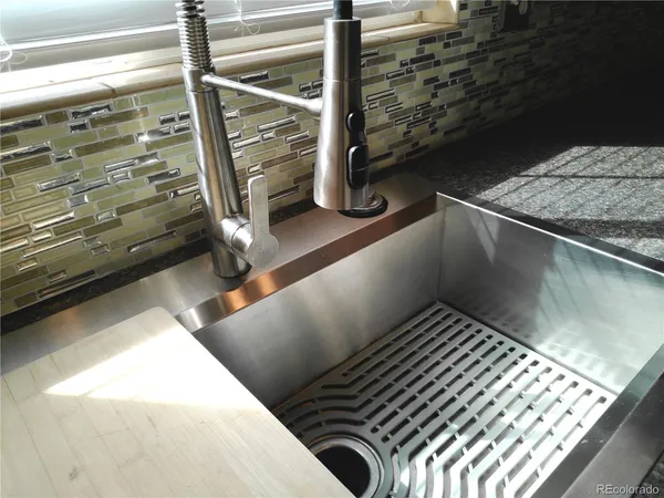 a kitchen with granite countertop a refrigerator stove and microwave