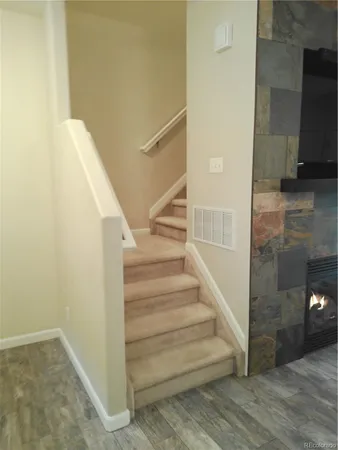 a view of a hallway with closet and mirror