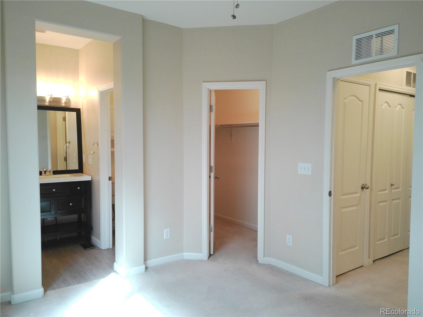 4714 ROWLAND Heights Colorado Springs, CO 80923 - Photo 19 of 41 a view of a hallway with closet and mirror