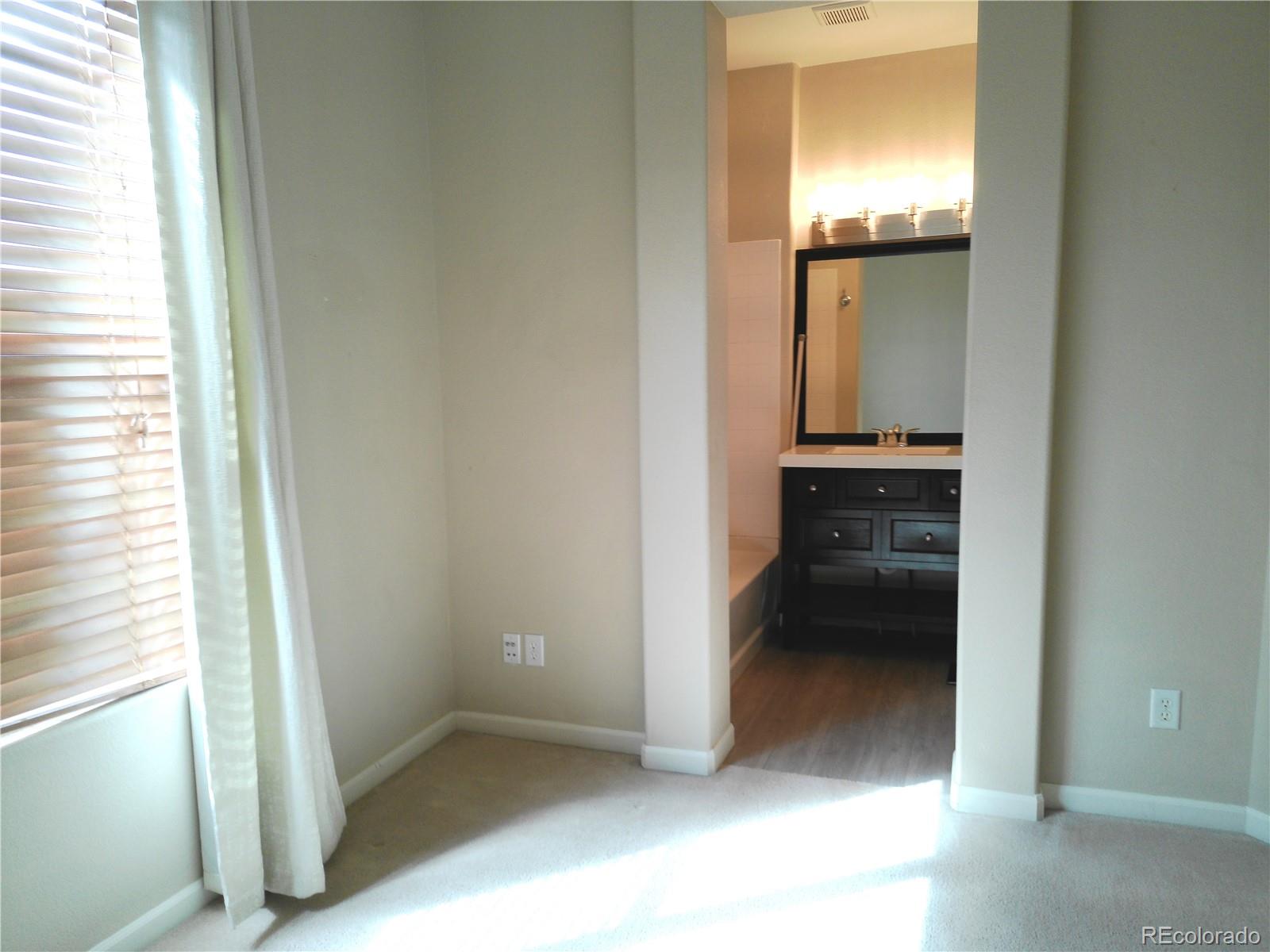 4714 ROWLAND Heights Colorado Springs, CO 80923 - Photo 20 of 41 a view of a bathroom from a corridor