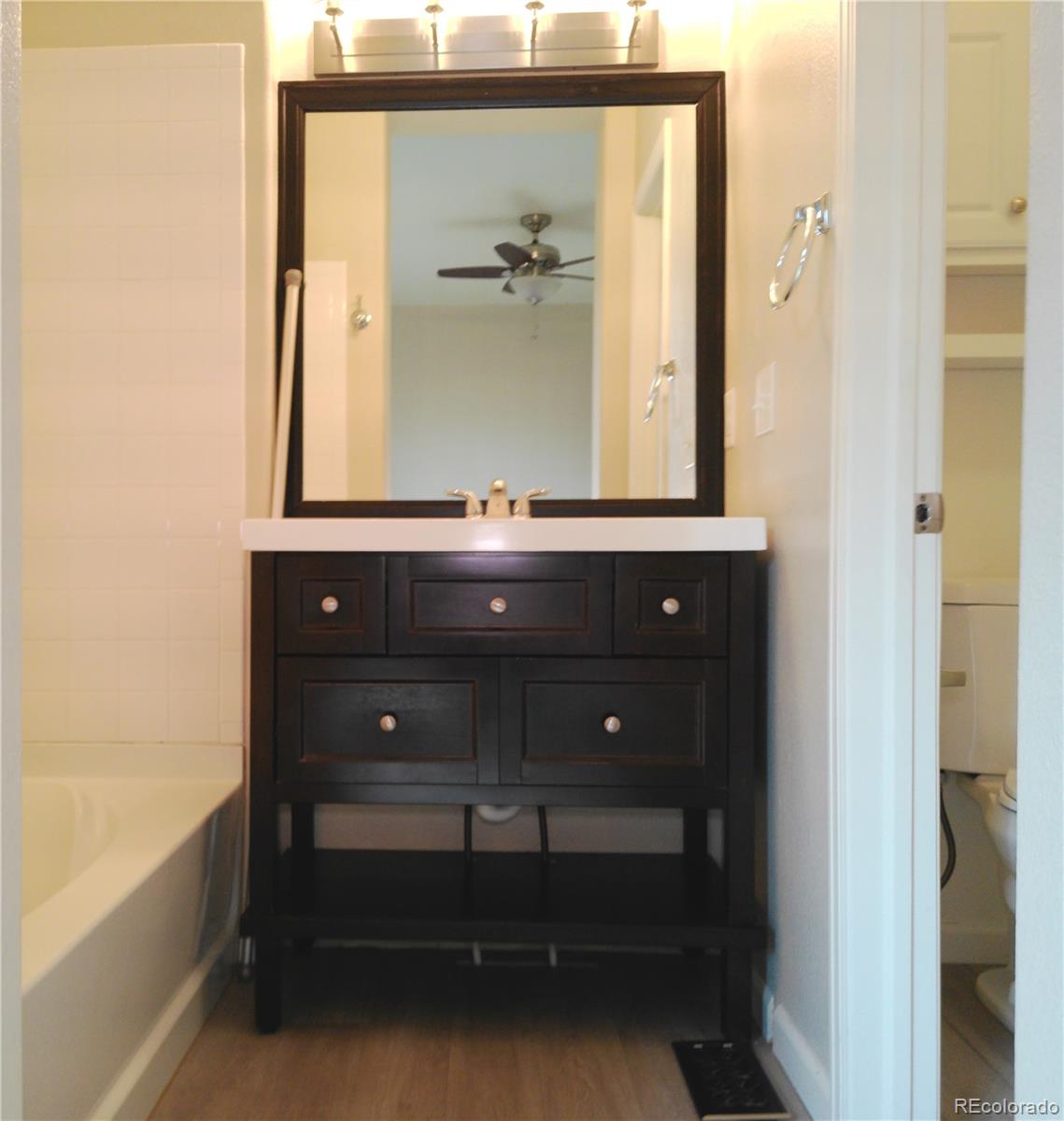 4714 ROWLAND Heights Colorado Springs, CO 80923 - Photo 21 of 41 a bathroom with a sink and a mirror