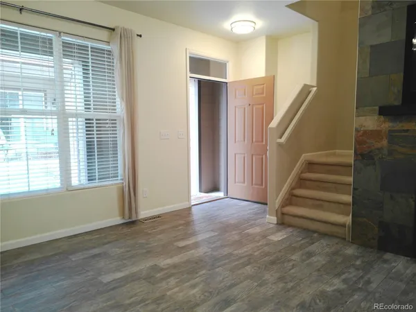 a view of entryway with stairs and wooden floor