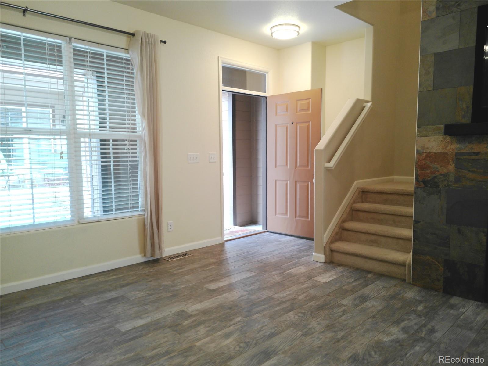 4714 ROWLAND Heights Colorado Springs, CO 80923 - Photo 3 of 41 a view of entryway with stairs and wooden floor