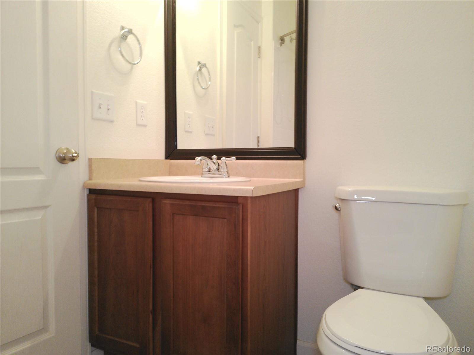 4714 ROWLAND Heights Colorado Springs, CO 80923 - Photo 31 of 41 a bathroom with a toilet sink and mirror