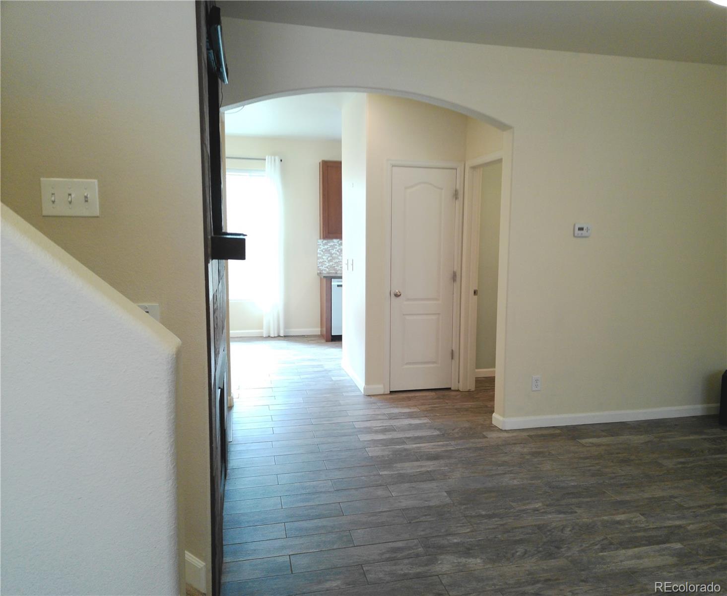 4714 ROWLAND Heights Colorado Springs, CO 80923 - Photo 4 of 41 a view of a hallway with wooden floor