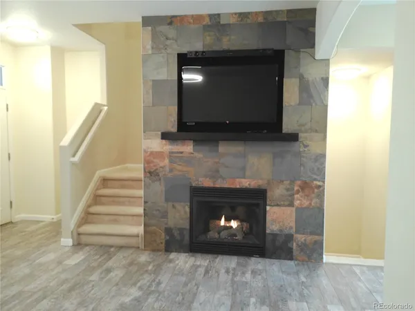a living room with a fireplace and a fireplace