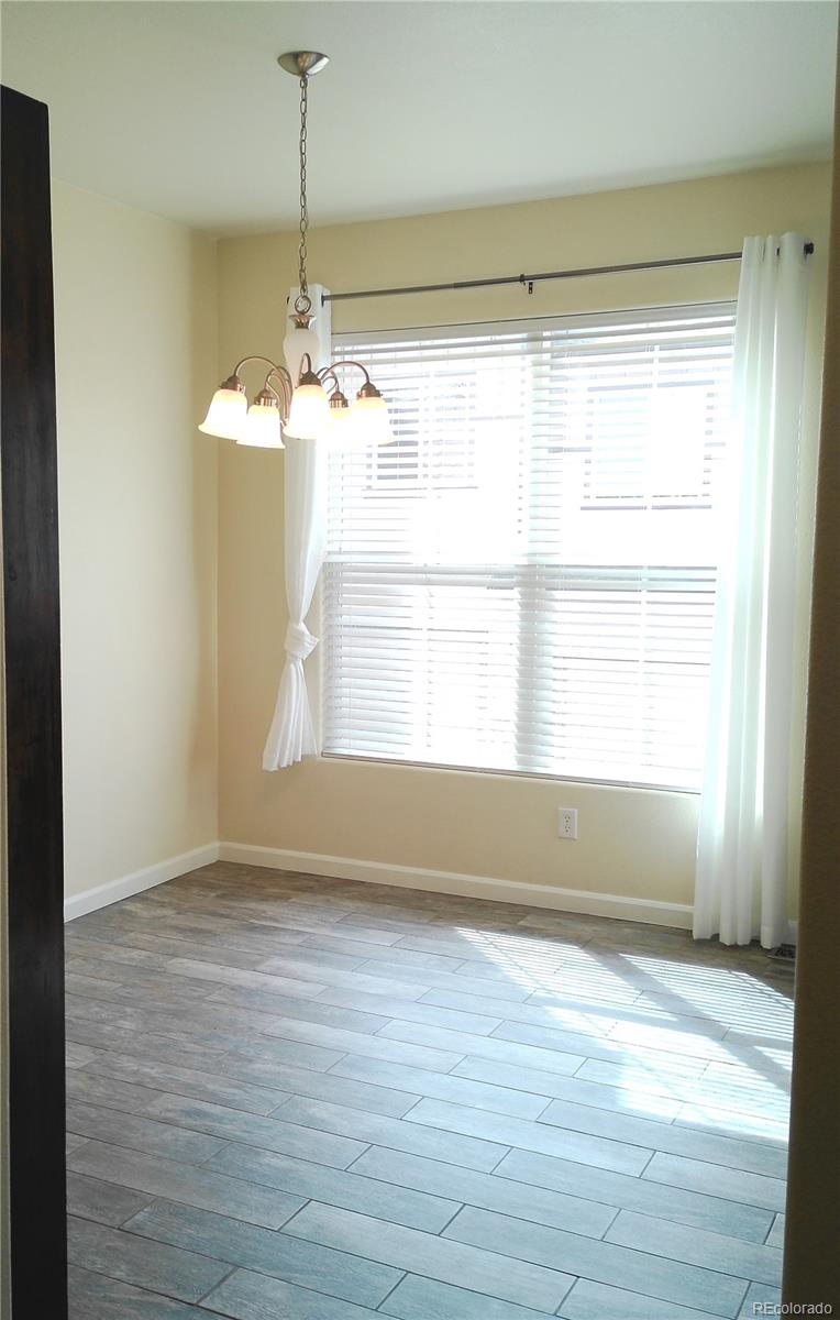 4714 ROWLAND Heights Colorado Springs, CO 80923 - Photo 9 of 41 a view of empty room with wooden floor and fan