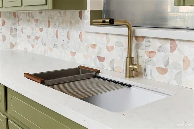 a kitchen with stainless steel appliances granite countertop a sink and wooden floor