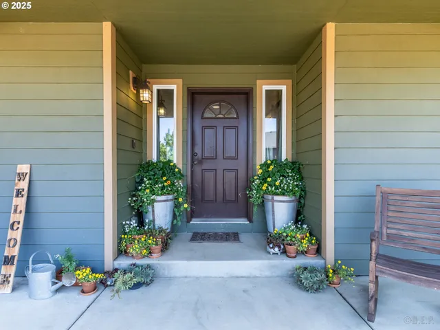 a front view of a house with potted plants