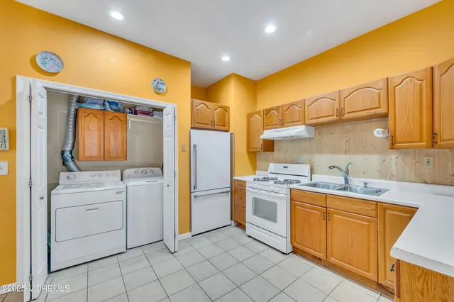 a kitchen with a sink stove and refrigerator