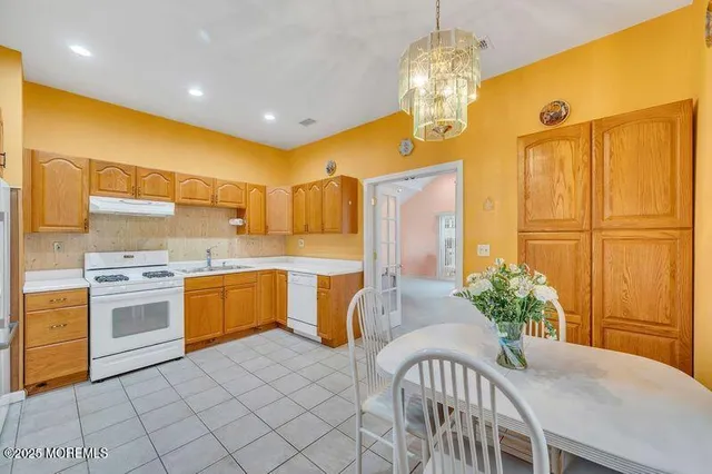 a kitchen with granite countertop a sink stainless steel appliances and cabinets