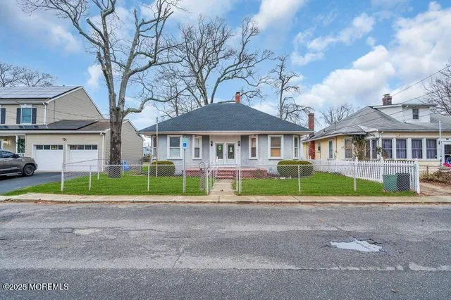 a front view of residential houses with yard and green space