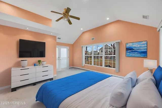 a bedroom with a bed window and flat screen tv