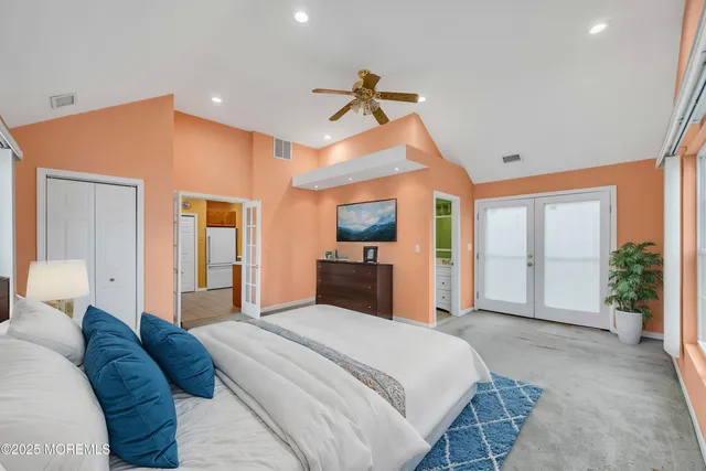 a bedroom with a large bed and a chandelier