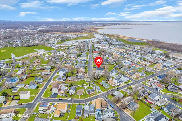 an aerial view of residential building and lake