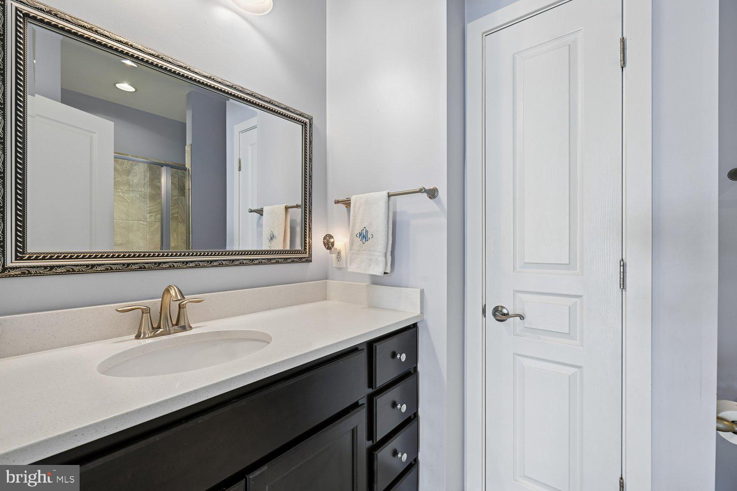 3068 Spring Peeper Court Odenton, MD 21113 - Photo 9 of 42 a bathroom with a double vanity sink and a mirror