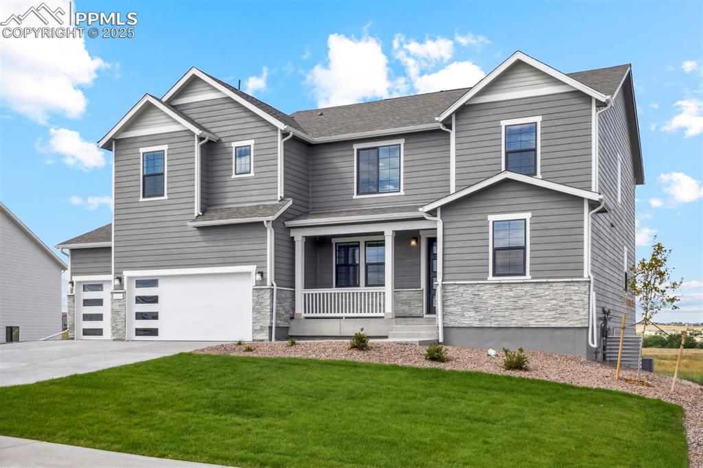 a front view of a house with a yard and garage