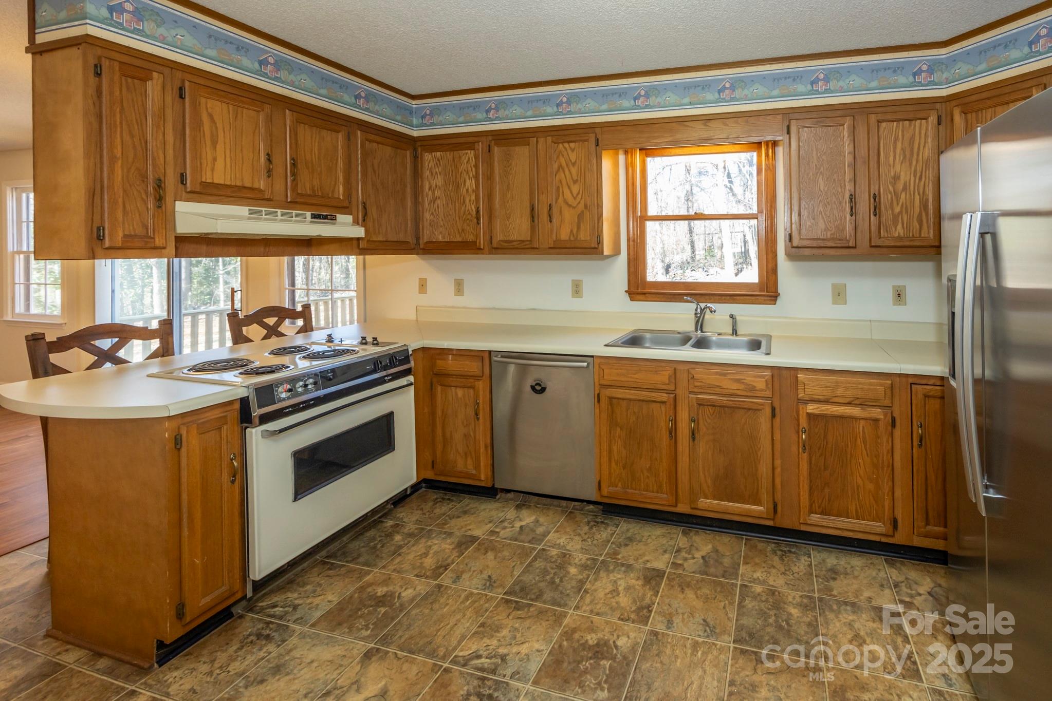395 Thompson Road Rutherfordton, NC 28139 - Photo 6 of 25 a kitchen with stainless steel appliances a sink a stove and a refrigerator