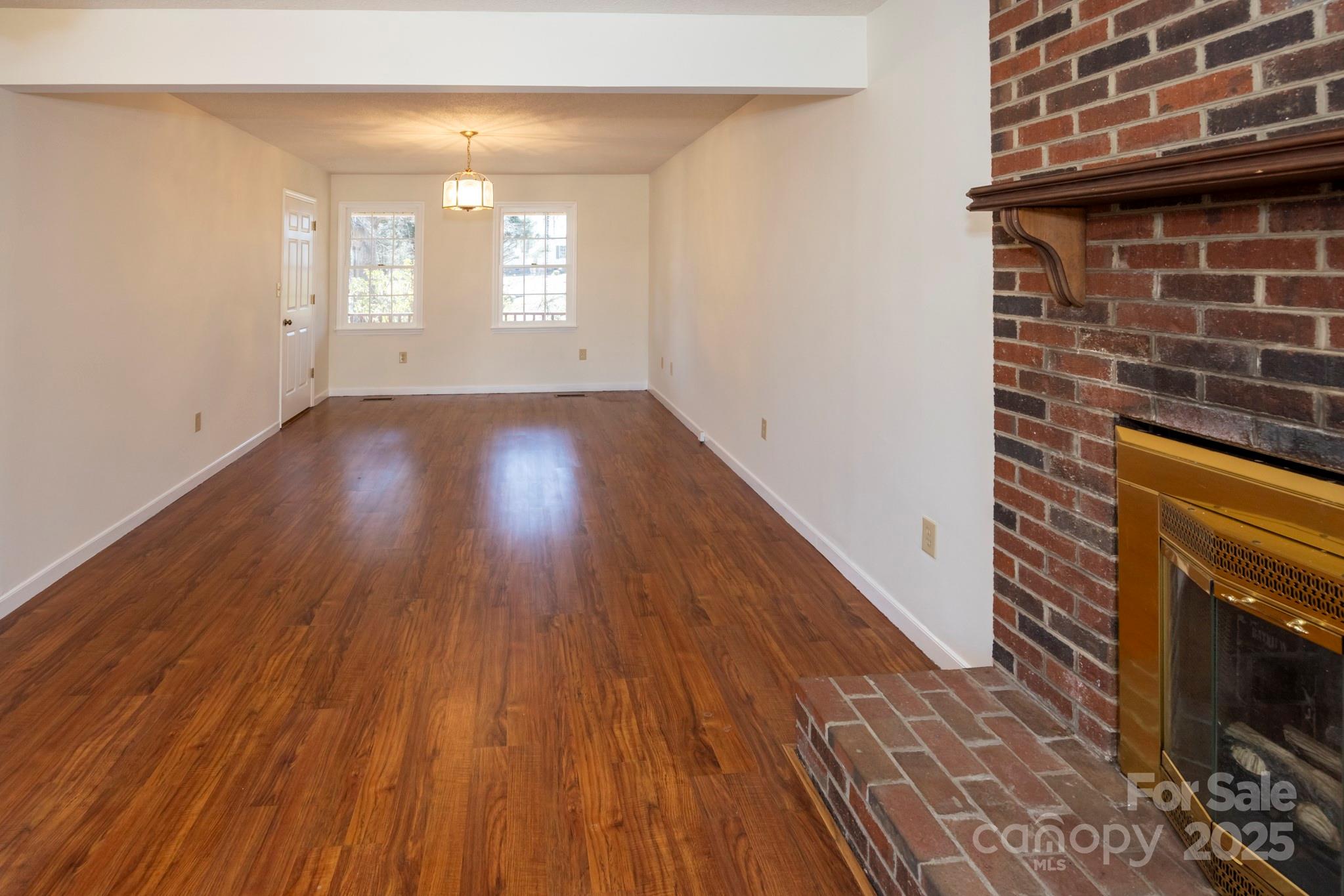 395 Thompson Road Rutherfordton, NC 28139 - Photo 7 of 25 a view of an empty room with wooden floor and a window
