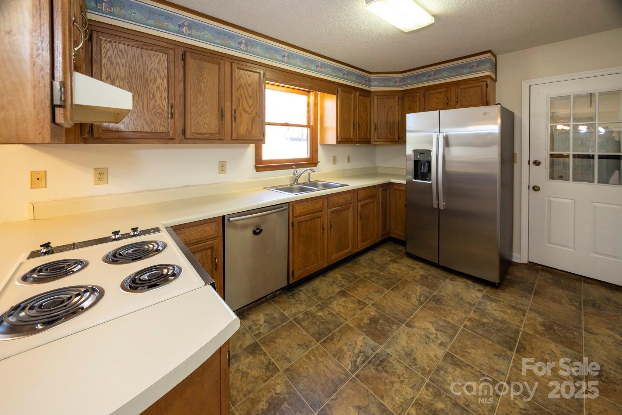 395 Thompson Road Rutherfordton, NC 28139 - Photo 9 of 25 a kitchen with stainless steel appliances granite countertop a sink a stove and refrigerator
