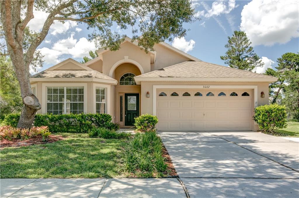 3062 Viewpoint Street Deltona, FL 32725 - Photo 1 of 1 a front view of a house with a garden