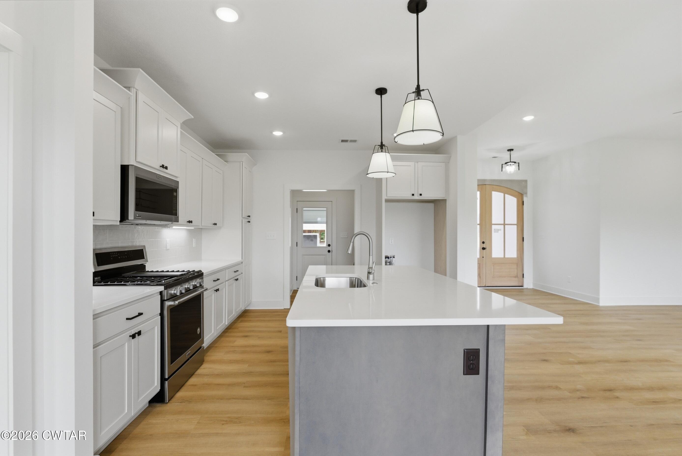 179 Daybreak Loop Medina, TN 38355 - Photo 6 of 32 a kitchen with kitchen island a sink stainless steel appliances and cabinets