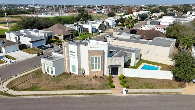 an aerial view of a house with a yard and garage