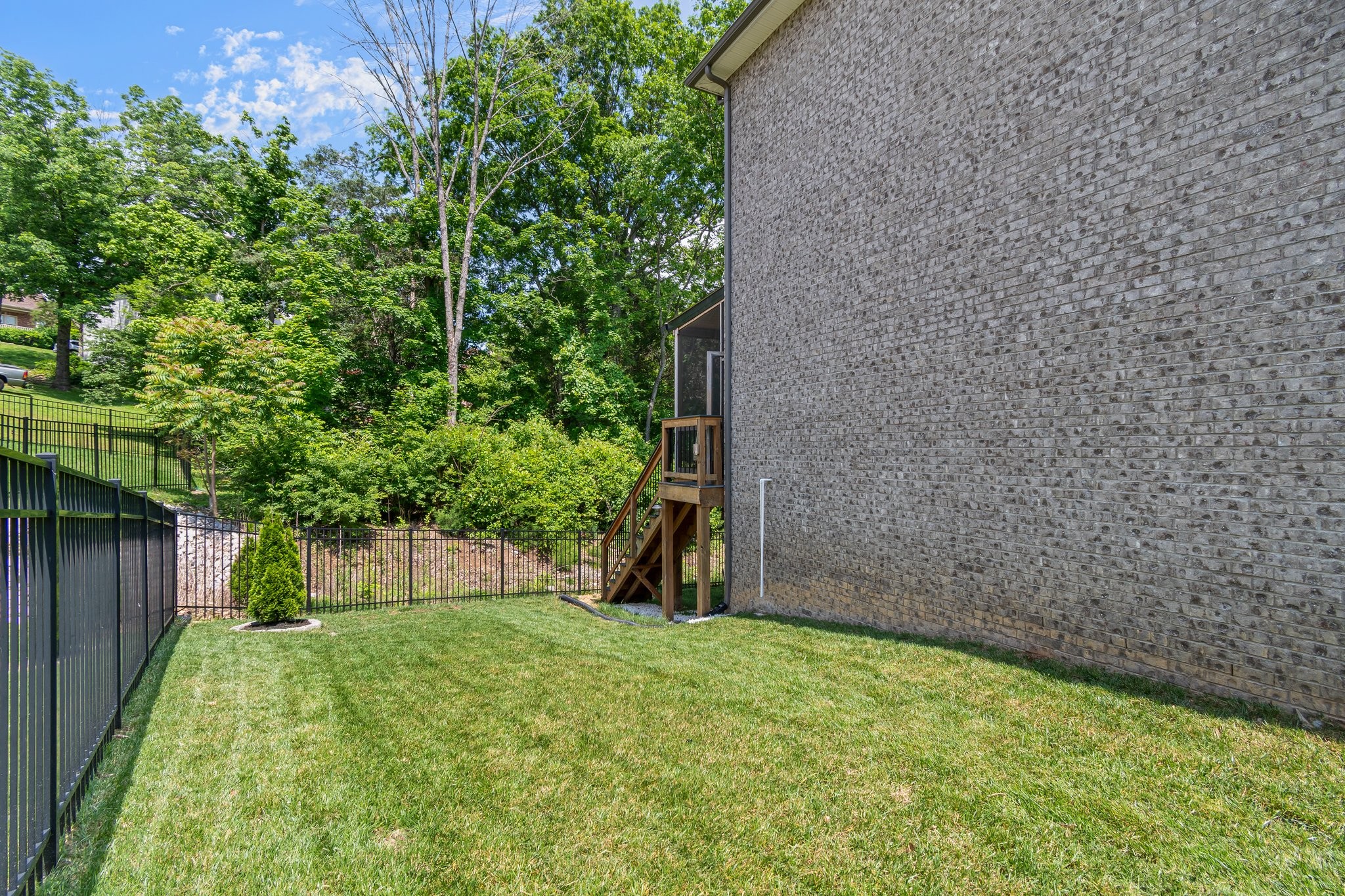 409 Eagle Ridge Nashville, TN 37209 - Photo 82 of 83 a backyard of a house with plants and wooden fence