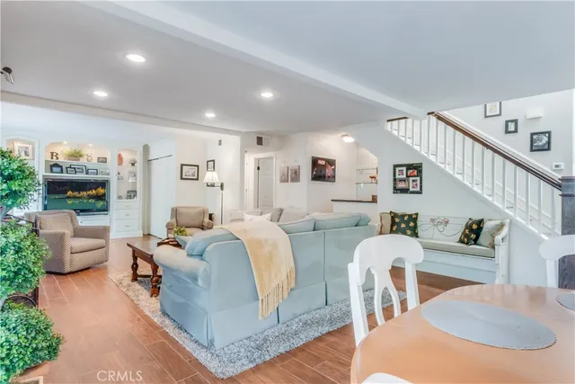 a living room with fireplace furniture and a wooden floor