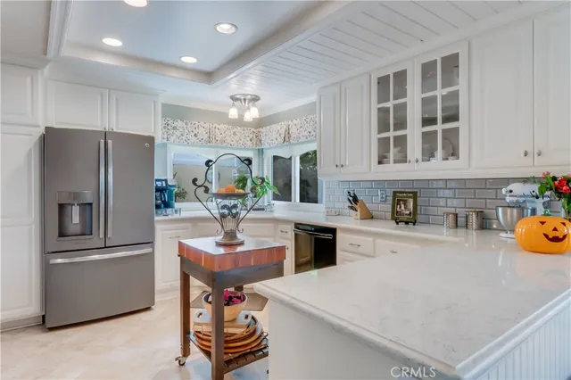 a kitchen with refrigerator a stove and a sink