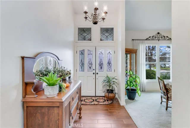 a living room with furniture a window and a chandelier