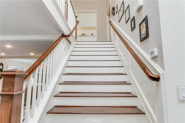 a view of a hallway with the wooden floor and staircase
