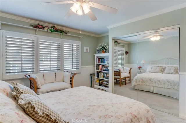 a bedroom with a bed dresser and window