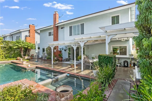 a view of house with swimming pool outdoor seating area and barbeque oven