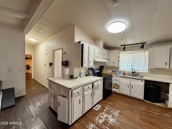 a kitchen with stainless steel appliances a sink a stove a refrigerator and cabinets