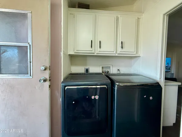 a utility room with sink dryer and washer
