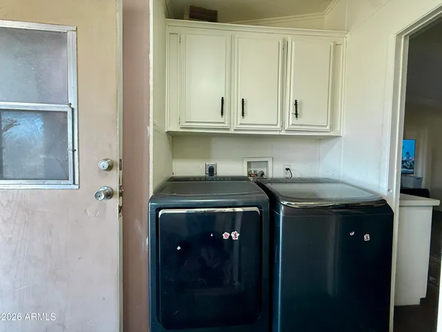 a utility room with sink dryer and washer
