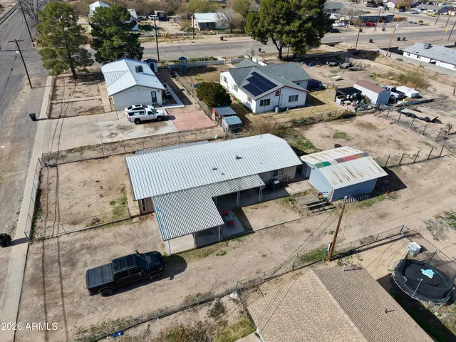 an aerial view of a house with swimming pool and outdoor seating
