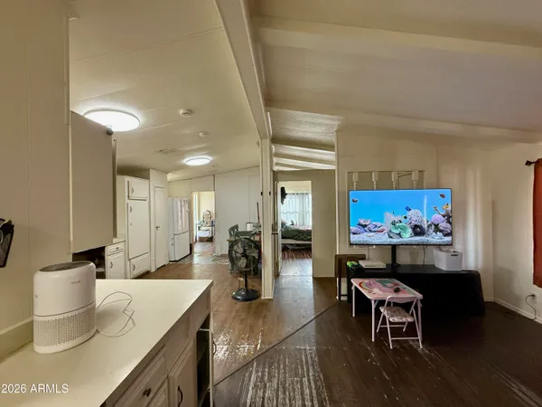 a living room with furniture a rug and a painting on the wall
