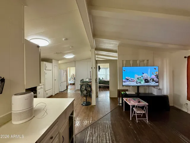 a living room with furniture a rug and a painting on the wall