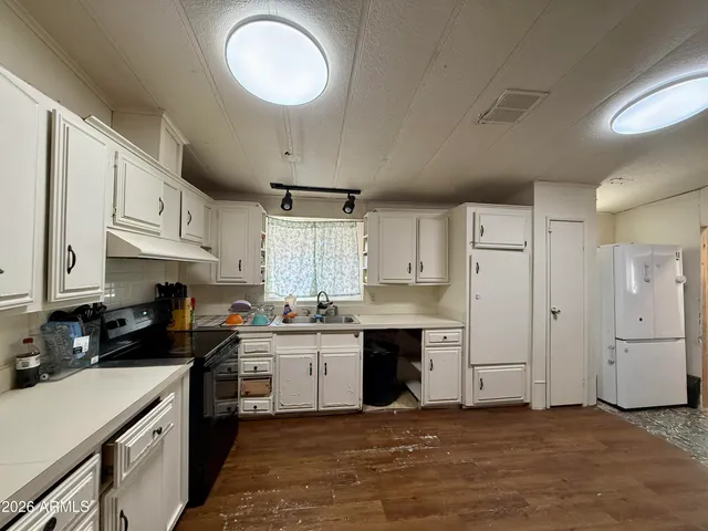 a kitchen with a sink a stove and refrigerator