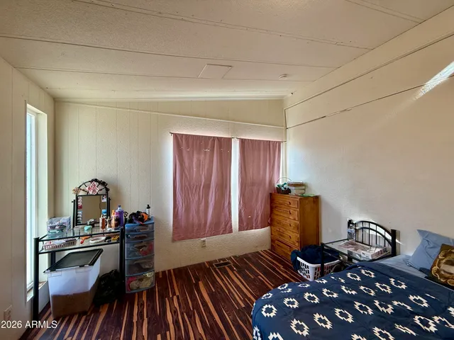 a bedroom with furniture and wooden floor